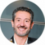 Jean Salvador, CEO da About Brazil, homem de meia idade, com barba, sorrindo